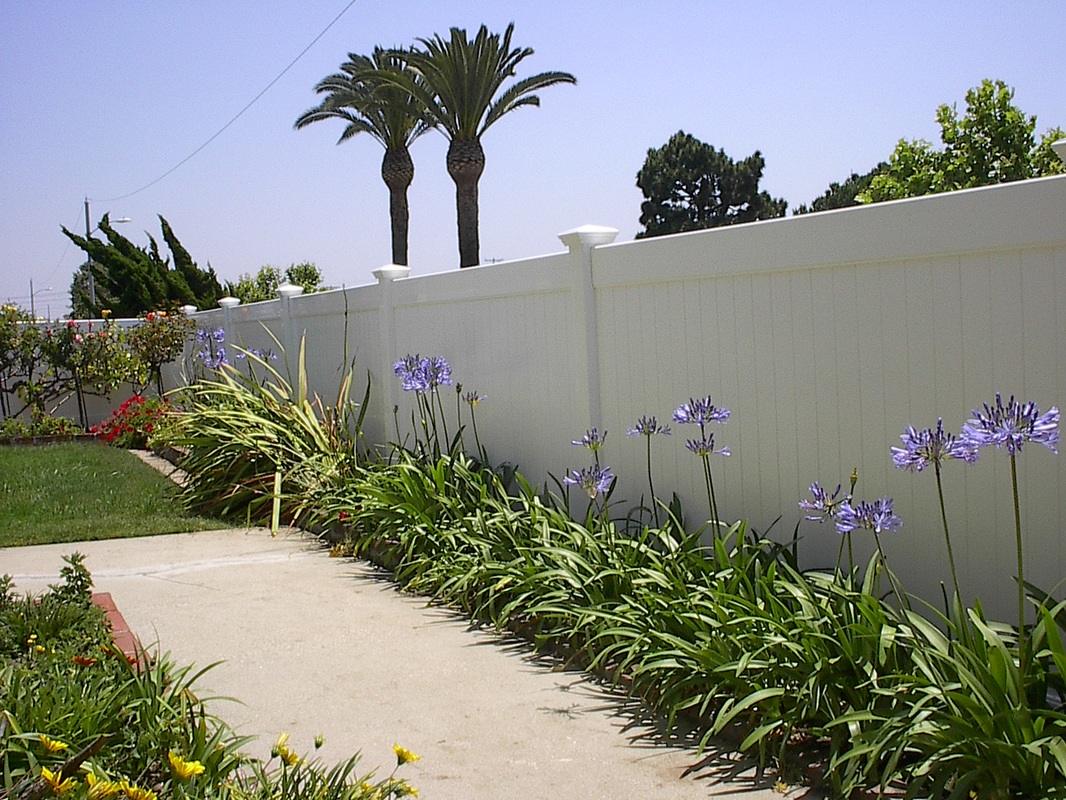 White vinyl privacy fencing can make your garden's colors come alive