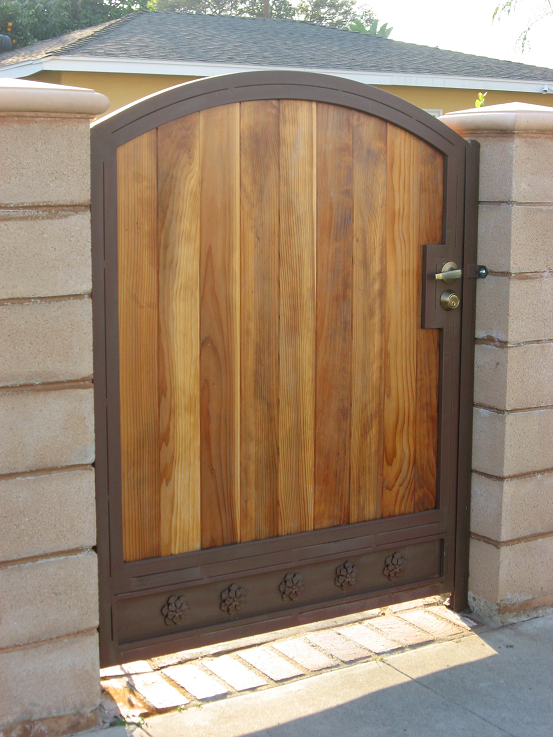 A beautiful arch top steel frame gate with wood inlay and a built in deadbolt lock and lever lock