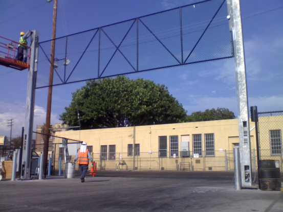 This is a vertical lift chain link gates with motors. It was installed at the Los Angeles Greyhound Terminal.