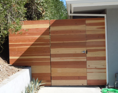 Horizontal wood fence and gates create a clean look. Note the lock built into the gate.